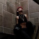 Stylish woman with tattoos and red hair posing in cool urban setting, Mexico City.